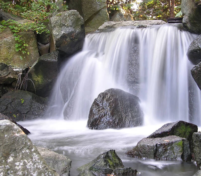 A waterfall with rocks and water flowing over it.